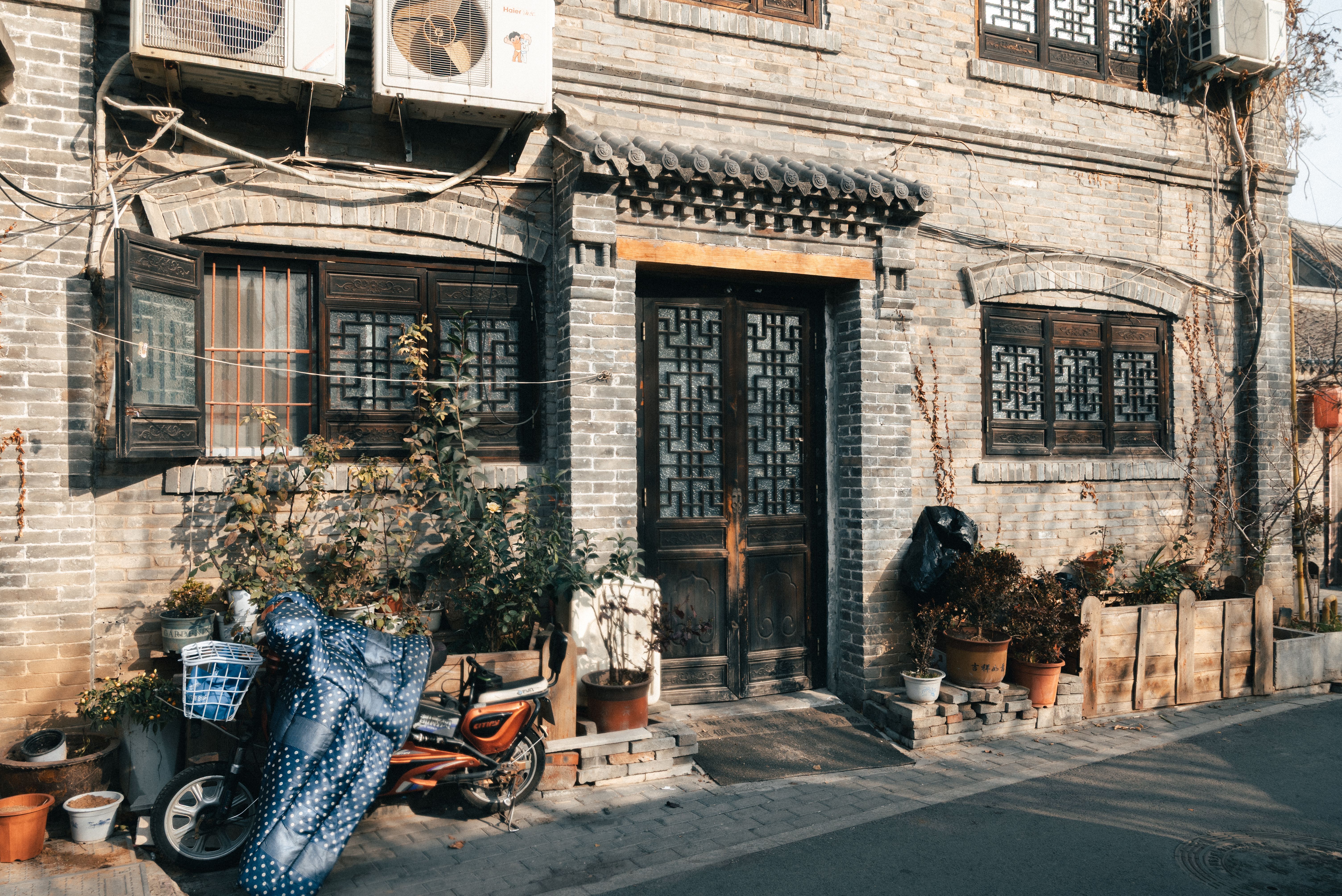 Rickshaw pulling through narrow Hutong alley
